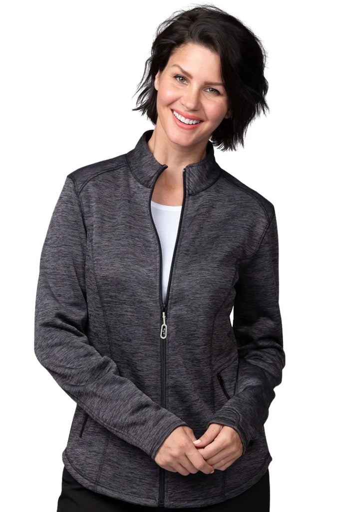 A young female Home Health Aide wearing an Ava Therese Women's Bonded Fleece Jacket in Heather Grey size 2XL featuring a two front zip close pockets.