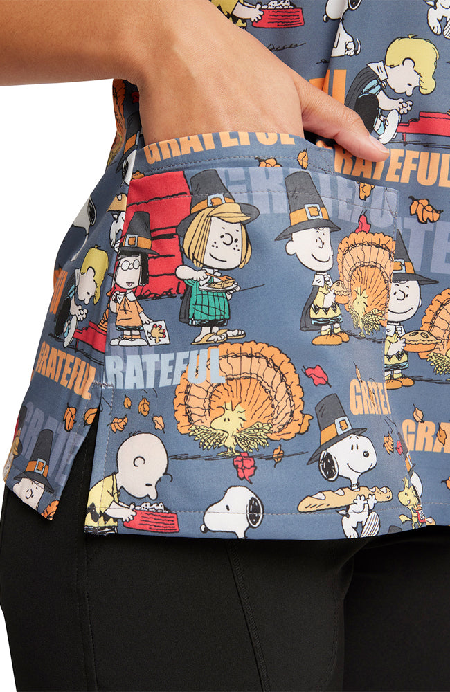 A close up shot of the right side patch pocket on the Tooniforms Women's V-Neck Thanksgiving Print Scrub Top in "Grateful Snoopy".
