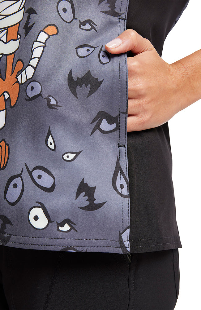 A close up shot of the contrast side panels on the Tooniforms Women's V-Neck Printed Scrub Top in "Under Wraps".