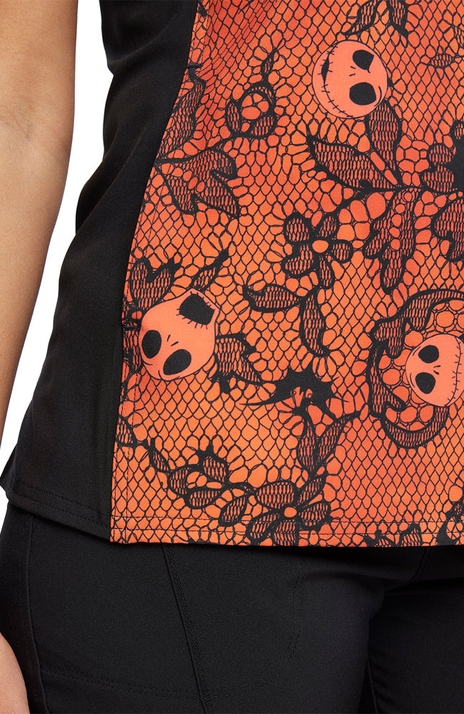 A close up shot of design of the Tooniforms Women's Halloween V-Neck Printed Scrub Top in "Undying Love" featuring floating Jack Skellington heads throughout.