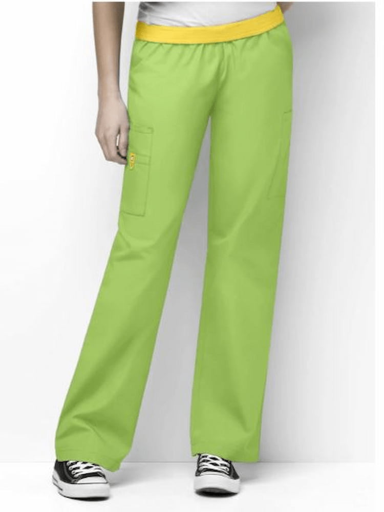 A young female EMT wearing a pair of WonderWink Women's Elastic Waist Cargo Pants in Green Apple size 5XL featuring a total of 8 pockets.