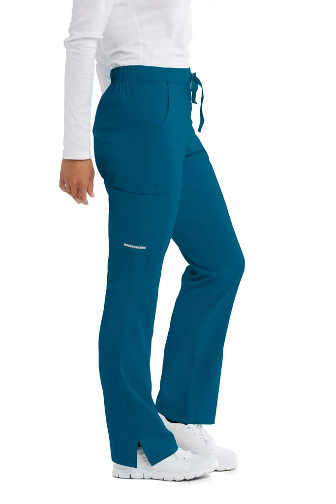 A close look at the right side of the Skechers Women's Reliance Cargo Scrub Pant in Bahama size Large featuring a side cargo pocket with the Skechers logo printed on the bottom.
