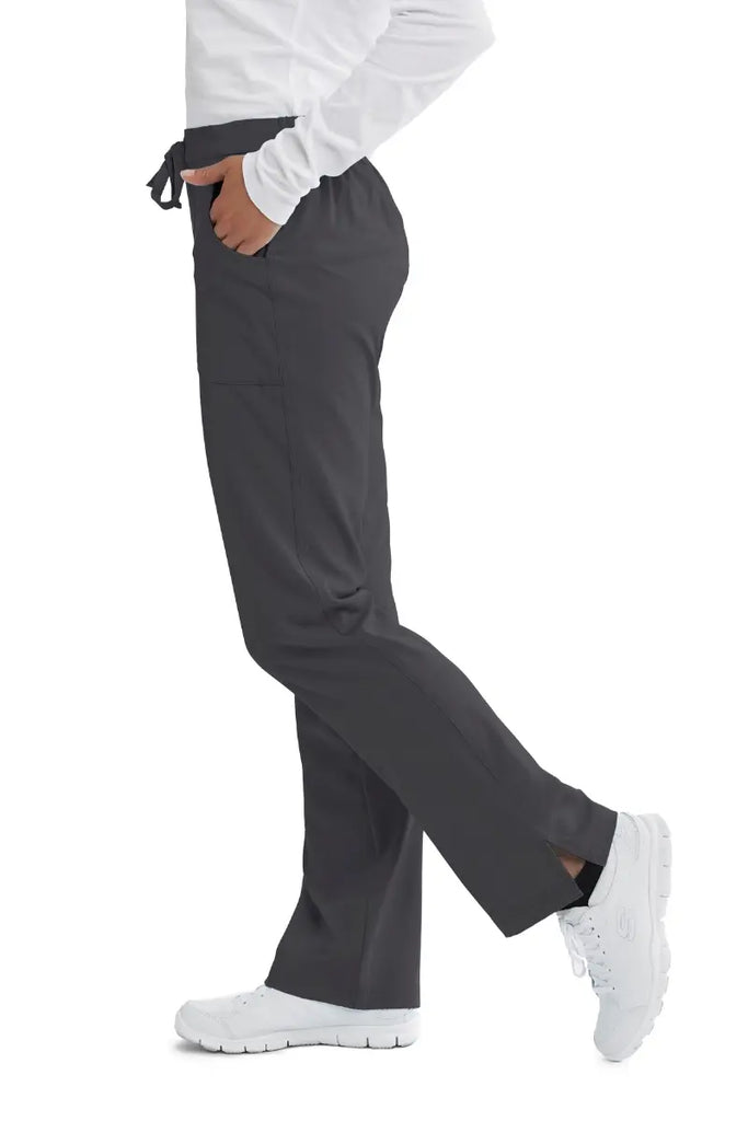 The left side of the Skechers Women's Reliance Cargo Scrub pant in Pewter size Medium featuring side vents at the hem.