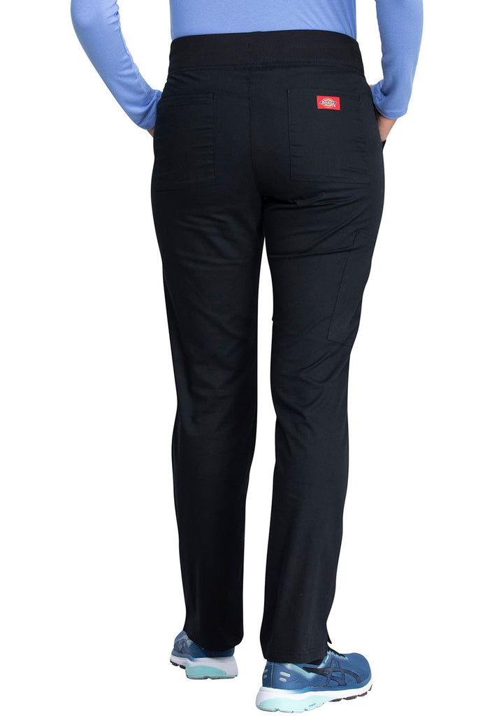 A young female Healthcare Professional wearing a Dickies EDS Signature Women's Mid Rise Pull-on Pant in Black size XS Petite featuring 2 back patch pockets for additional on the go storage needs.