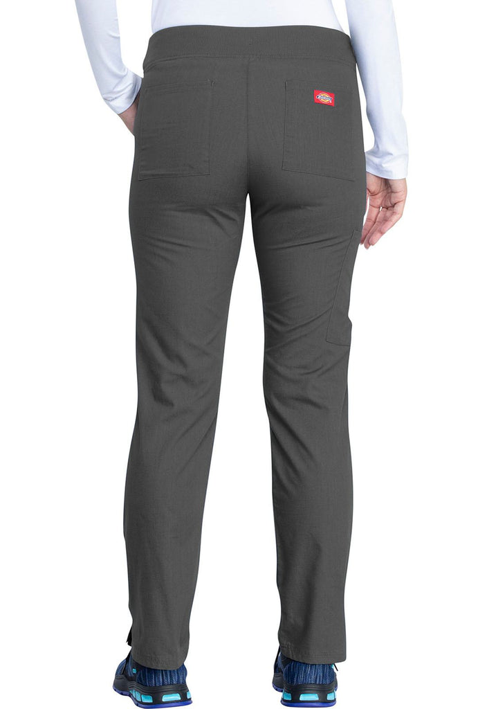 A young female Healthcare Professional wearing a Dickies EDS Signature Women's Mid Rise Pull-on Pant in Pewter size XS featuring 2 back patch pockets for additional on the go storage needs.