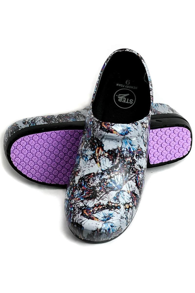 A view of the bottom & front of the StepZ Women's Slip Resistant Memory Foam Clog in "Granite Glory" size 7 featuring a classic slip-on style & a heel height of roughly 1.5".