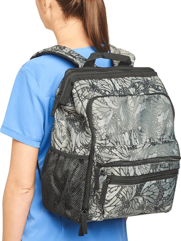 An image of a young female nures wearing a Nursemates Ultimate Backpack in Jacquard Butterfly featuring adjustable back straps to ensure a comfortable fit.