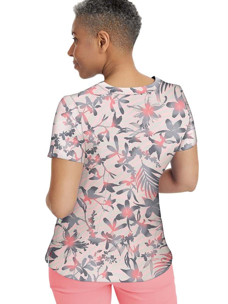 A female nurse wearing a Healing Hands Women's Amanda Print Top in "Surf's Up" featuring back shaping darts for a flattering fit.