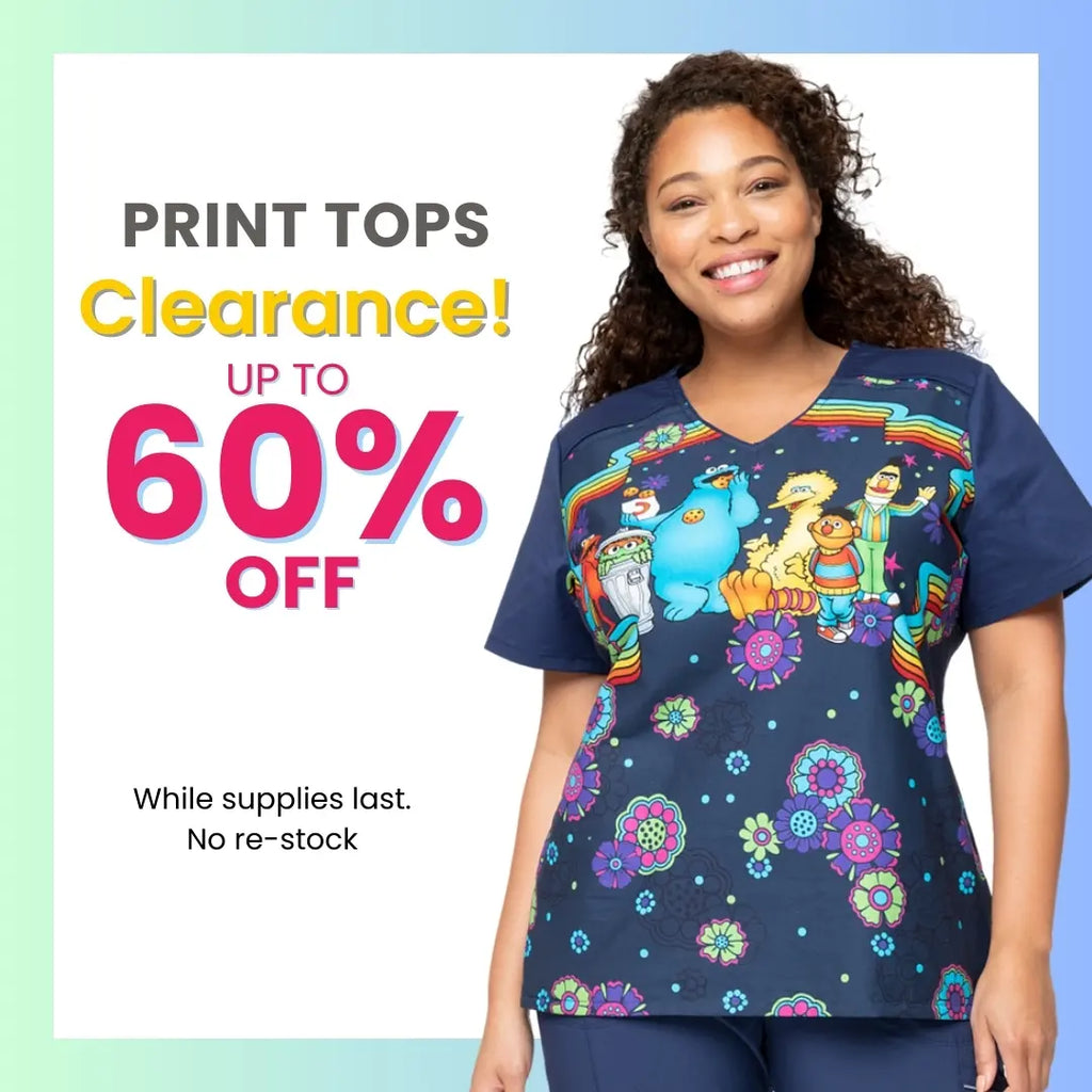 A young female Pediatric Nurse wearing a Printed Scrub Top on a white background featuring text to the left that states printed scrub tops are up to 60% off at Scrub pro Uniforms while supplies last.