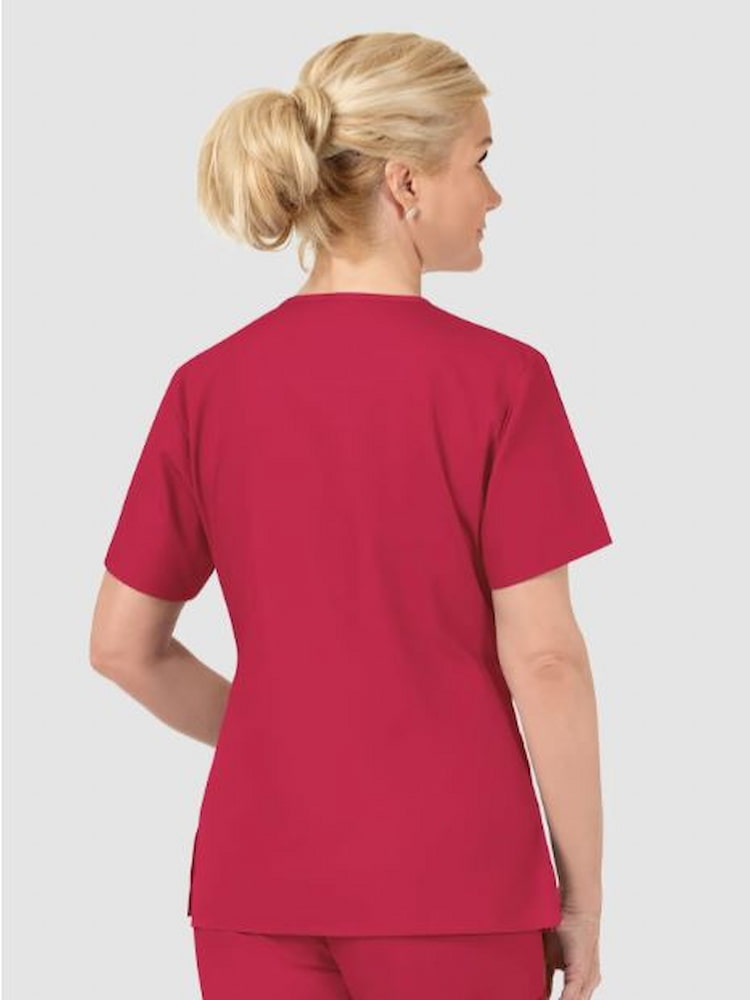 A middle aged Labor & Delivery Nurse wearing a WonderWink Origins Women's Bravo V-neck Scrub Top in Red size Medium featuring vented sides.