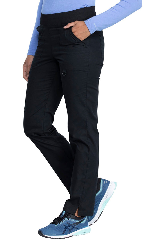 A young female Nurse wearing a Dickies EDS Signature Women's Mid Rise Tapered Leg Pull-on Pant in Black size Small featuring an adjustable interior drawstring.