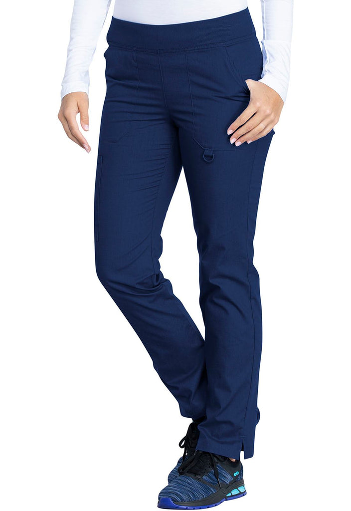 A young female Nurse wearing a Dickies EDS Signature Women's Mid Rise Tapered Leg Pull-on Pant in Navy size Small featuring an adjustable interior drawstring.