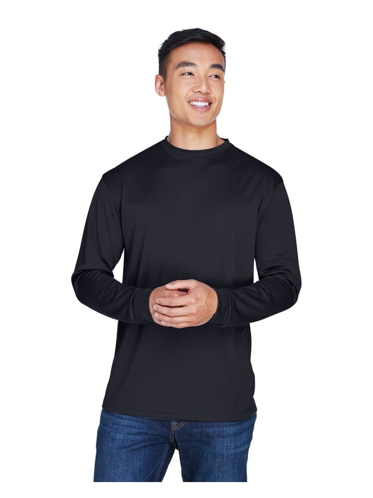 A young male Physical Therapist wearing an UltraClub Men's Cool & Dry Long Sleeve T-Shirt in Black size XL featuring an athletic design with a moisture wicking fabric to keep you cool & comfortable all day.