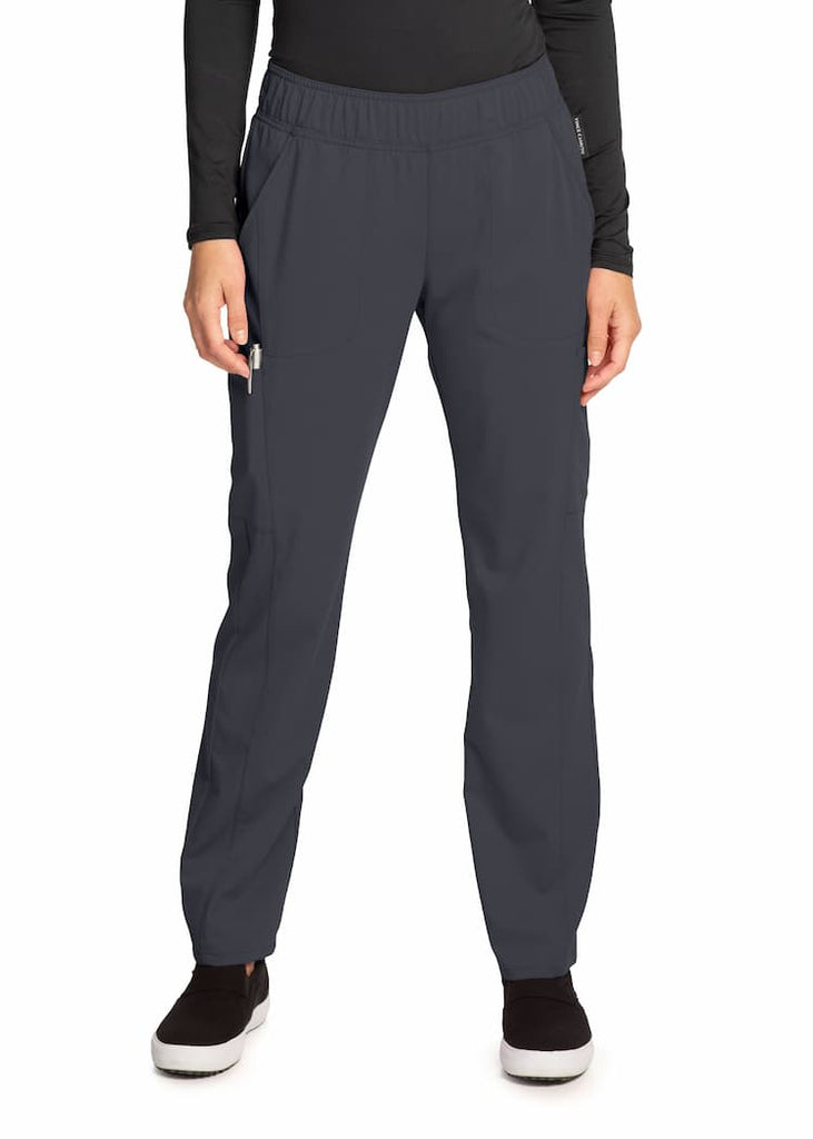 An image of a young female LPN wearing a Vince Camuto Women's Mid Rise Pull-On Pant in Pewter size  Small Petite featuring a Modern Fit with an adjustable internal drawstring.