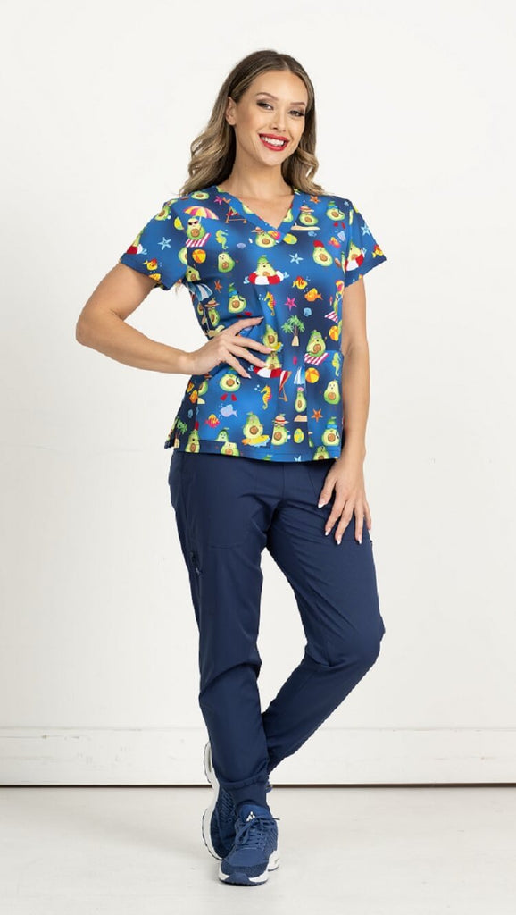 A young female Phlebotomist wearing a Meraki Sport Women's Print Scrub Top in "Avocado Paradise" size 2XL featuring shoulder yokes & side slits for additional range of motion.