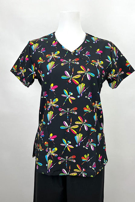 A frontward facing image of the Revel Women's Mock Wrap Print Scrub Top in "Jeweled Dragonflies" size Medium featuring a stylish mock wrap neckline & 2 curved front patch pockets.