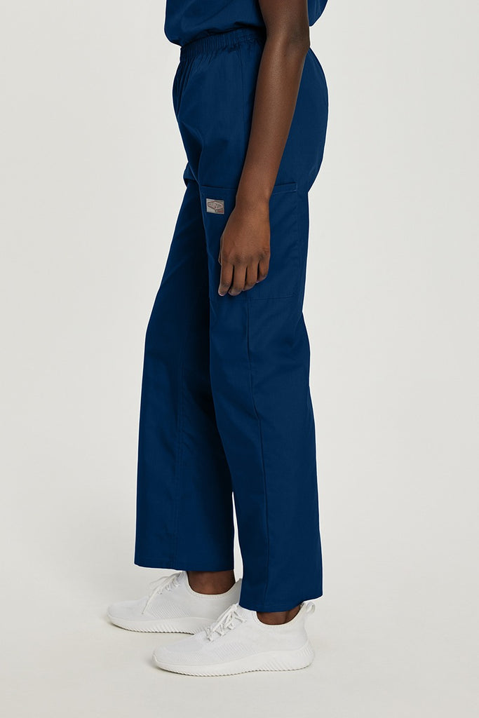 A young female Clinical Laboratory Technician wearing a Landau ScrubZone Women's Elastic Waist Cargo Pant in True Navy size Small Petite featuring a single cargo pocket on the wearer's left side. 