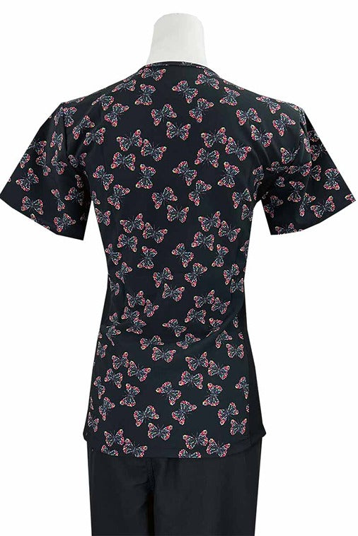 An Essentials Women's Mock Wrap Side Panels Scrub Top in "Butterfly Flecks" featuring 2 front patch pockets & 1 exterior utility pocket on the wearer's right side.
