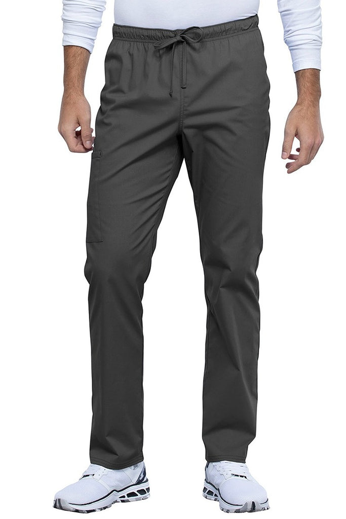 A picture of a male Nurse Practitioner wearing a Cherokee Unisex Straight Leg Scrub Pant in Pewter size XL Tall featuring a Bi-Stretch, durable fabric.