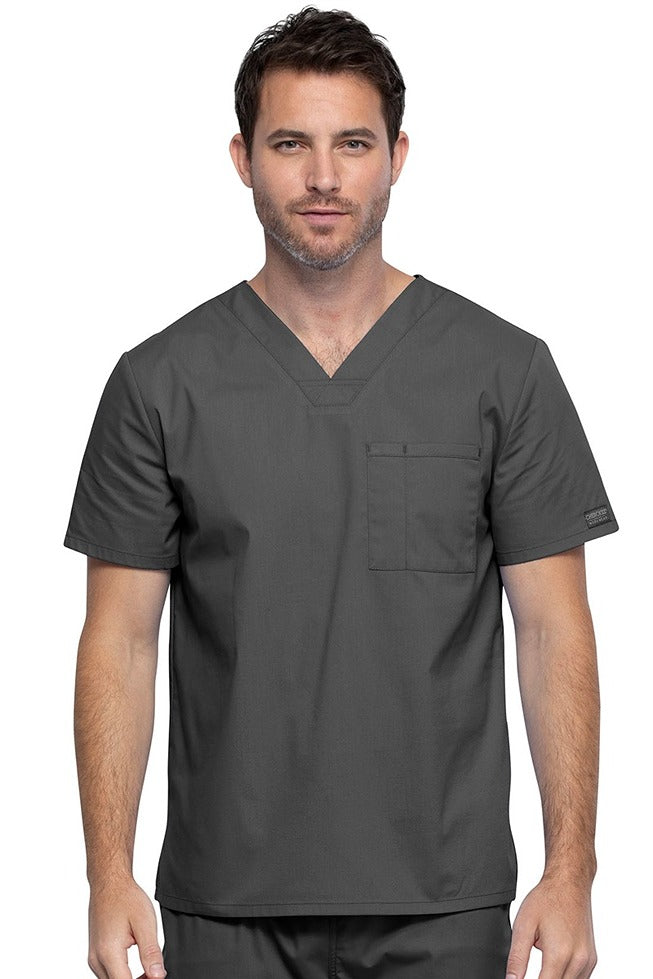 A middle aged Male Physician wearing a Cherokee Unisex Tuck-in V-neck Scrub Top in Pewter size XL featuring 1 front chest pocket.