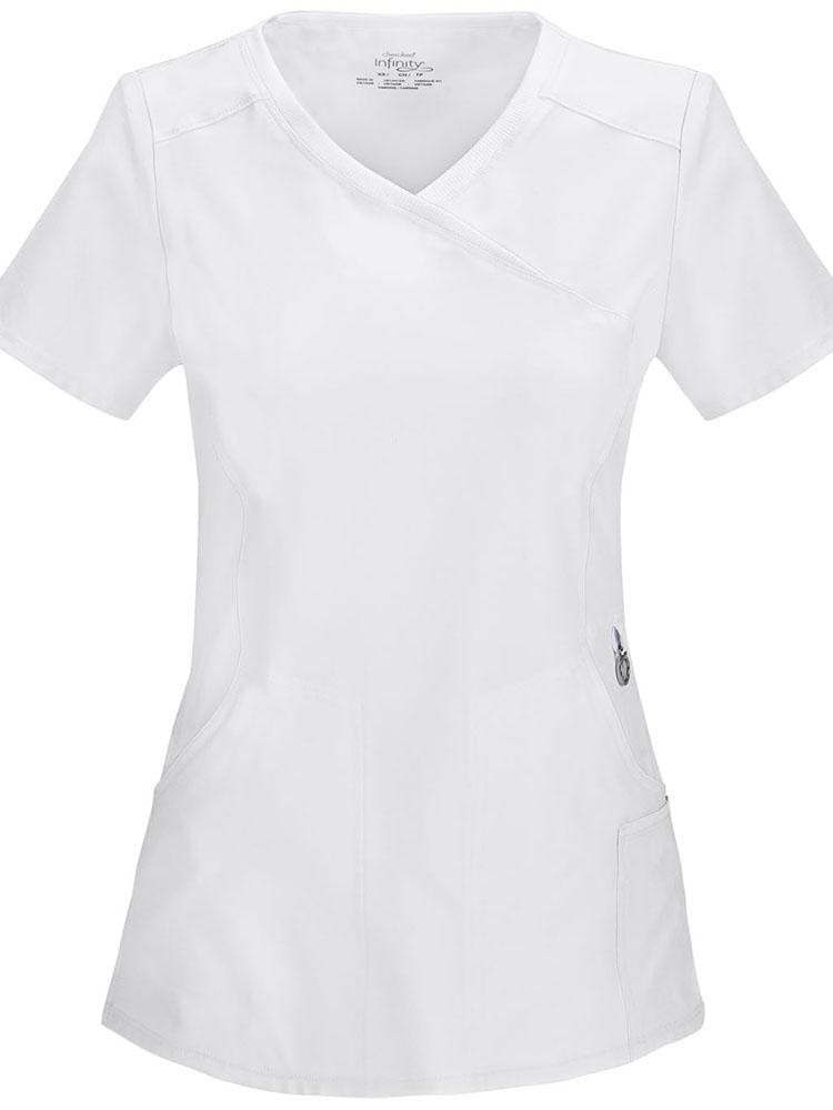 A frontward facing image of the Cherokee Infinity Women's Antimicrobial Mock Wrap Top in white size small featuring a left scissor pocket & one interior pocket.