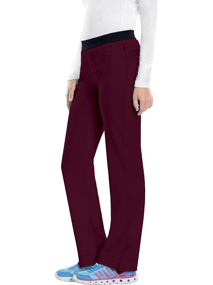 A young female Diagnostic Medical Sonographer wearing a Cherokee Infinity Women's Low-Rise Slim Pull On Scrub Pant in Wine size XL Tall featuring an elastic waistband.