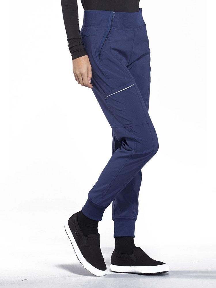 Cherokee Infinity Women's Mid Rise Tapered Jogger in navy featuring a cargo pocket with reflective tape