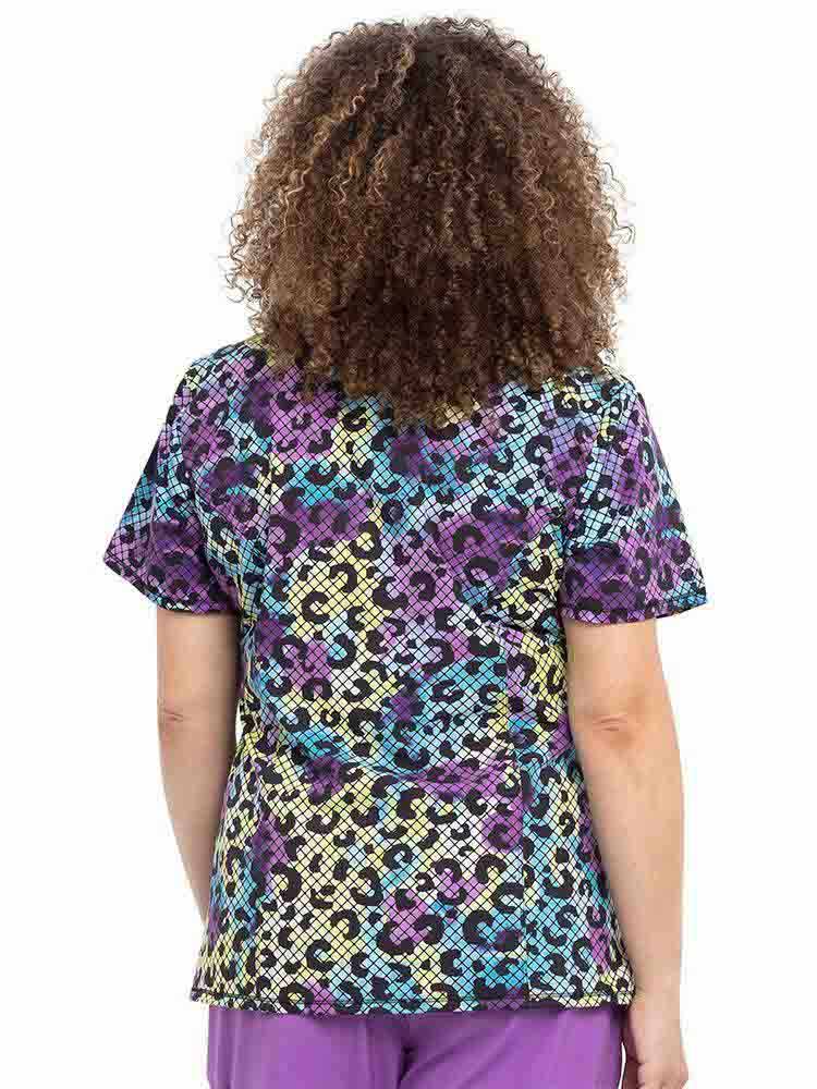 The back of the Infinity Women's Mock Wrap Scrub Top in "Wild Mesh" size medium featuring a center back length of 26".