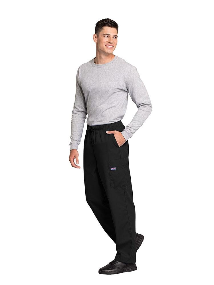 A male Nursing Assistant wearing a Cherokee Workwear Originals Men's Drawstring Cargo Scrub Pant in Black size XL featuring 2 front slash pockets & a functional zip fly.