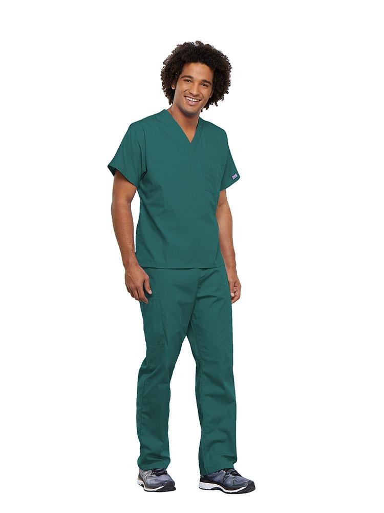 A male Surgical Technician wearing a Cherokee Workwear Originals unisex Single Pocket V-Neck Scrub Top in Teal size 5XL featuring 1 spacious chest pocket.