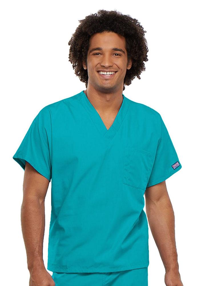 A young male Registered Nurse wearing a Cherokee Workwear Originals Unisex Single Pocket V-neck Scrub Top in Turquoise size 4XL featuring short sleeves.