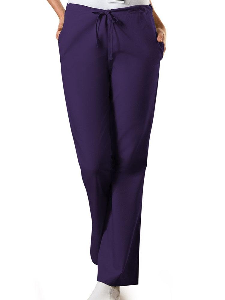 A young female Nursing Assistant wearing a Cherokee Workwear Originals Women's Drawstring Flare Leg Scrub Pant in Eggplant size Medium Petite featuring a Modern Classic fit.