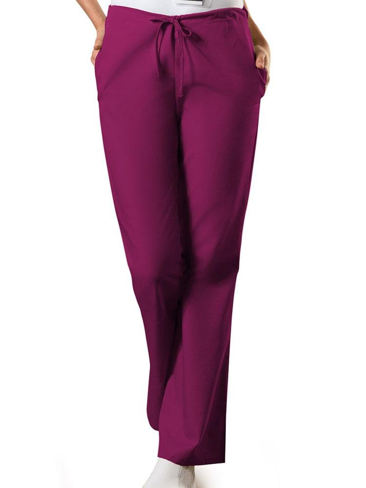 A young female Nurse wearing a Cherokee Workwear Originals Women's Drawstring Flare Leg Scrub Pant in Wine size Large Petite featuring a Modern Classic fit.
