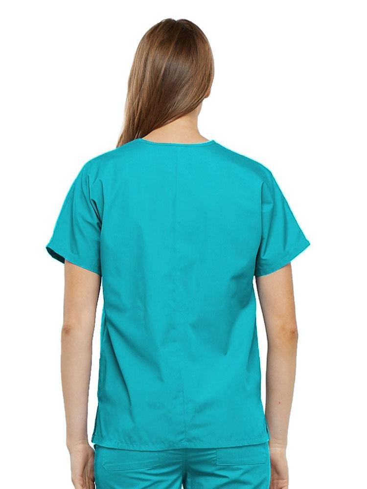 A young female Home Health Aide wearing a Cherokee Workwear Originals Women's V-neck Scrub Top in Turquoise size medium featuring a center back length of 26.5".
