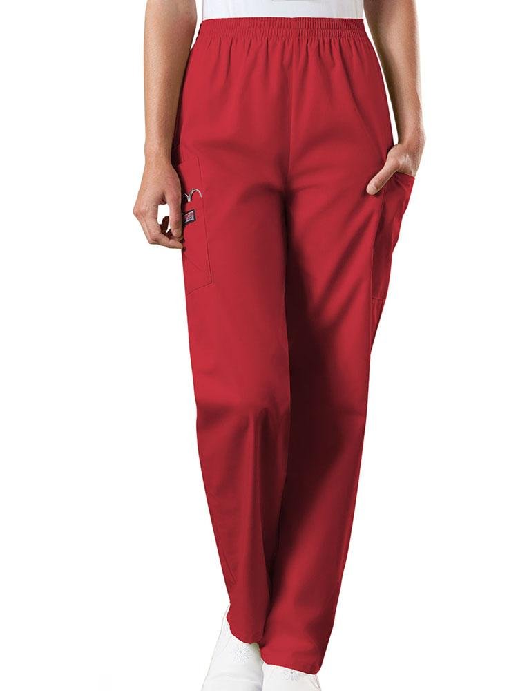A young female Radiologic Technologist wearing a pair of Women's Natural Rise Tapered Pull-On Scrub Pant from Cherokee Workwear Originals in Red size XL featuring a total of 4 pockets.