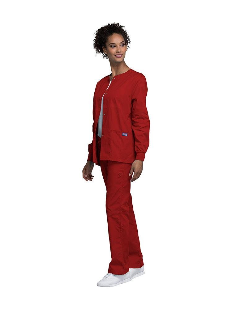 Medical Secretary wearing Cherokee Workwear Originals women's Snap Front Warm-Up Jacket in Red size extra small featuring knit cuffs to provide a flattering all day fit.