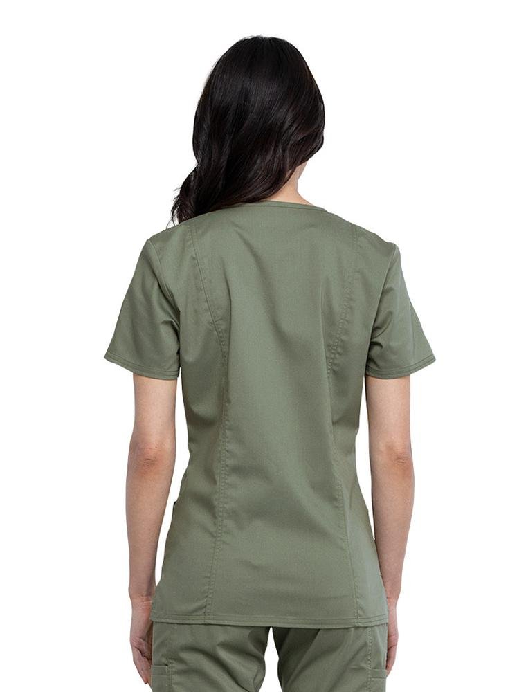 Back view of Licensed Vocational Nurse wearing Cherokee Workwear Revolution women's Mock Wrap Scrub Top in olive size small