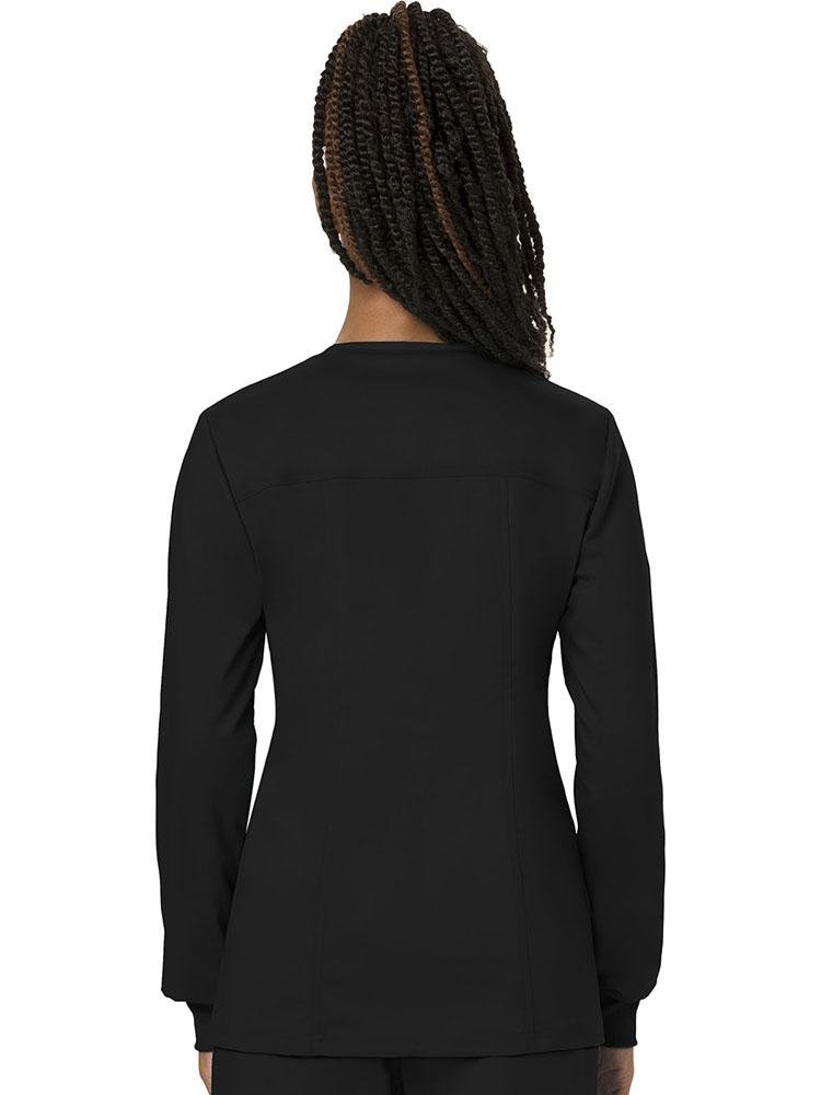 A female LPN wearing a Cherokee Workwear Women's Revolution Women's Snap Front Jacket in Black size 2XL featuring a center back length of approximately 26".