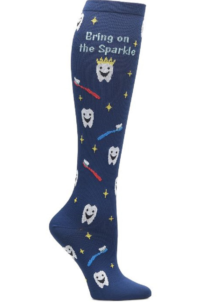 An image of the side of the of Women's Compression Socks from NurseMates in "Dental Sparkle" featuring a unique print with smiling teeth and multi-colored toothbrushes on a navy blue background with yellow stars scattered throughout.