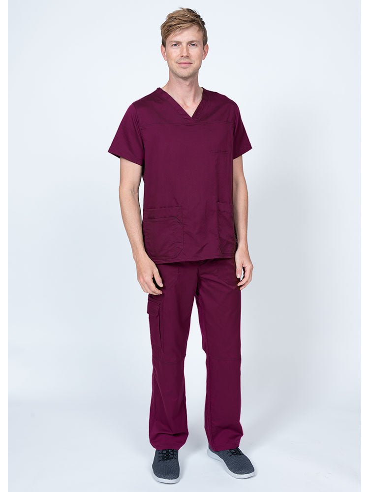 Man wearing an Epic by MedWorks Men's Scrub Top in wine with a super soft, 2-way stretch fabric.