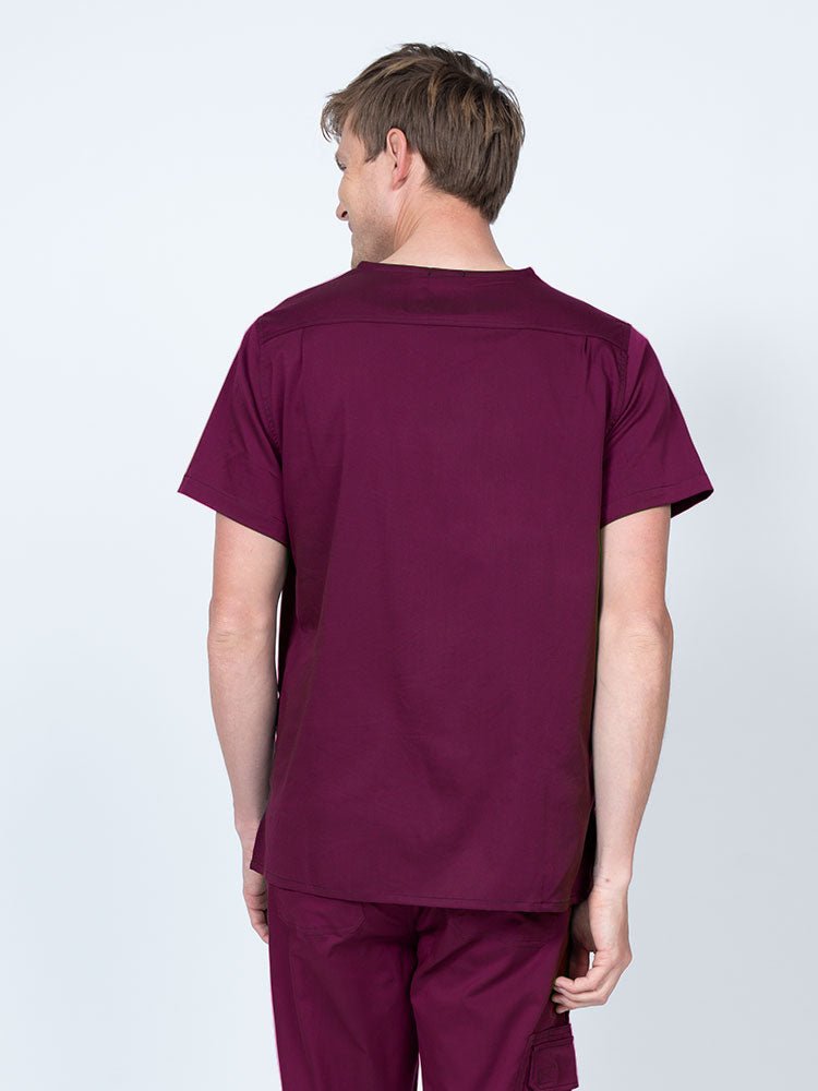 Male nurse wearing an Epic by MedWorks Men's Scrub Top in wine with a back yoke to keep a form-fitting look.