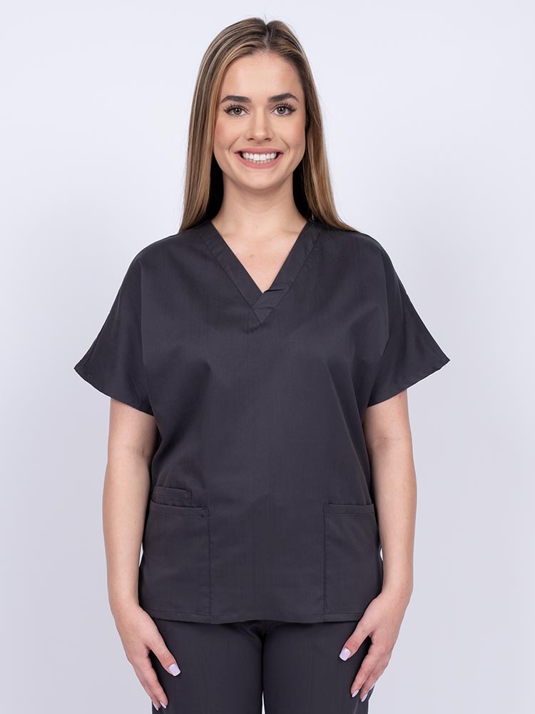 Young nurse wearing an Epic by MedWorks Unisex V-Neck Scrub Top in pewter with a unique, easy care fabric made of 77% polyester, 21% Viscose and 2% Spandex.