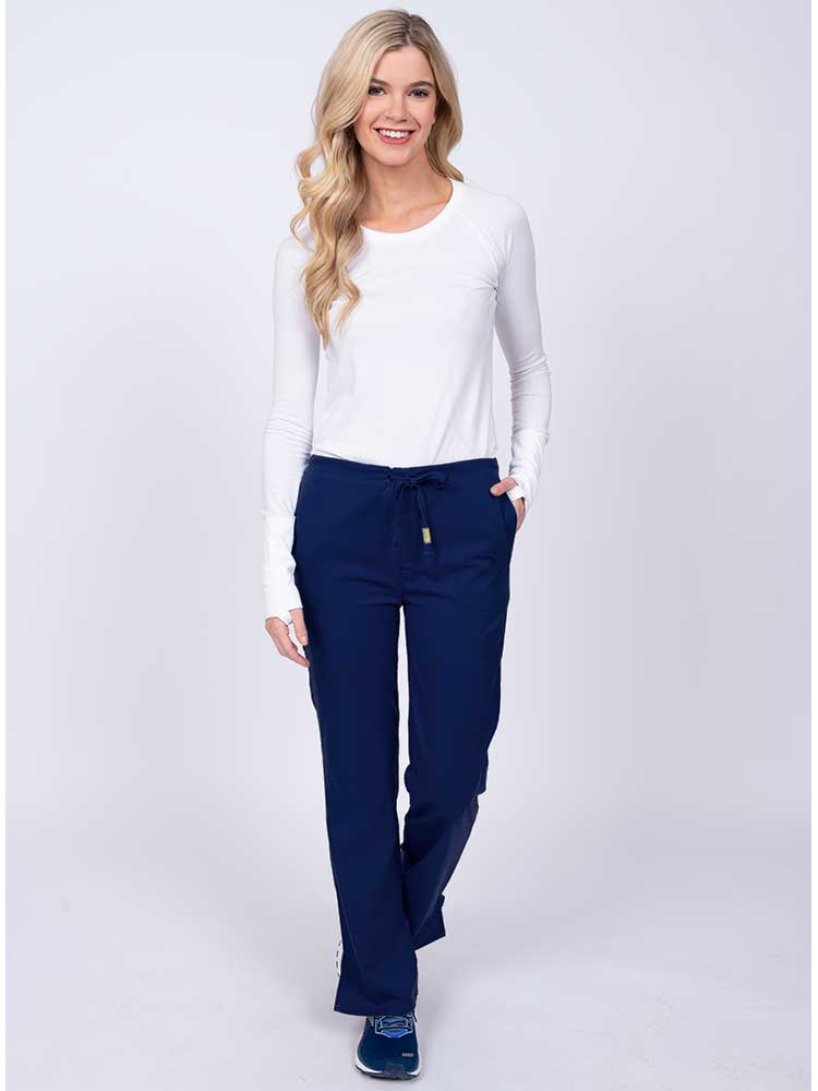 Woman wearing an Epic by MedWorks Women's Drawstring Flare Leg Scrub Pant in navy with 2 front slash pockets & 1 back pocket.