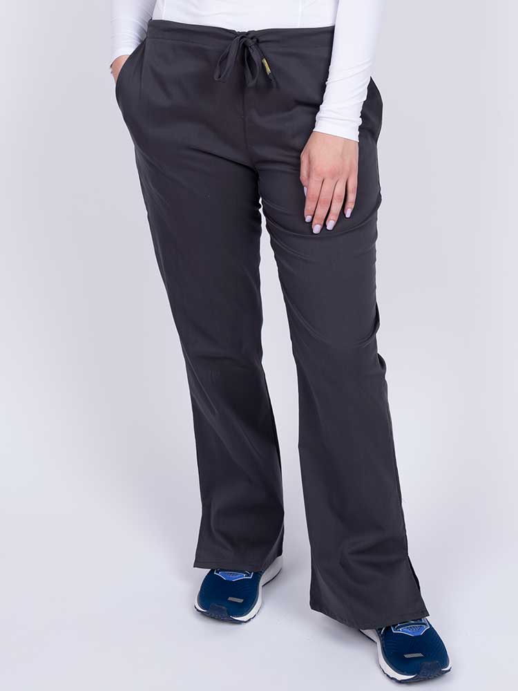 Young nurse wearing an Epic by MedWorks Women's Drawstring Flare Leg Scrub Pant in pewter with unique stretch fabric made of 77% Polyester, 21% Viscose, 2% Spandex.