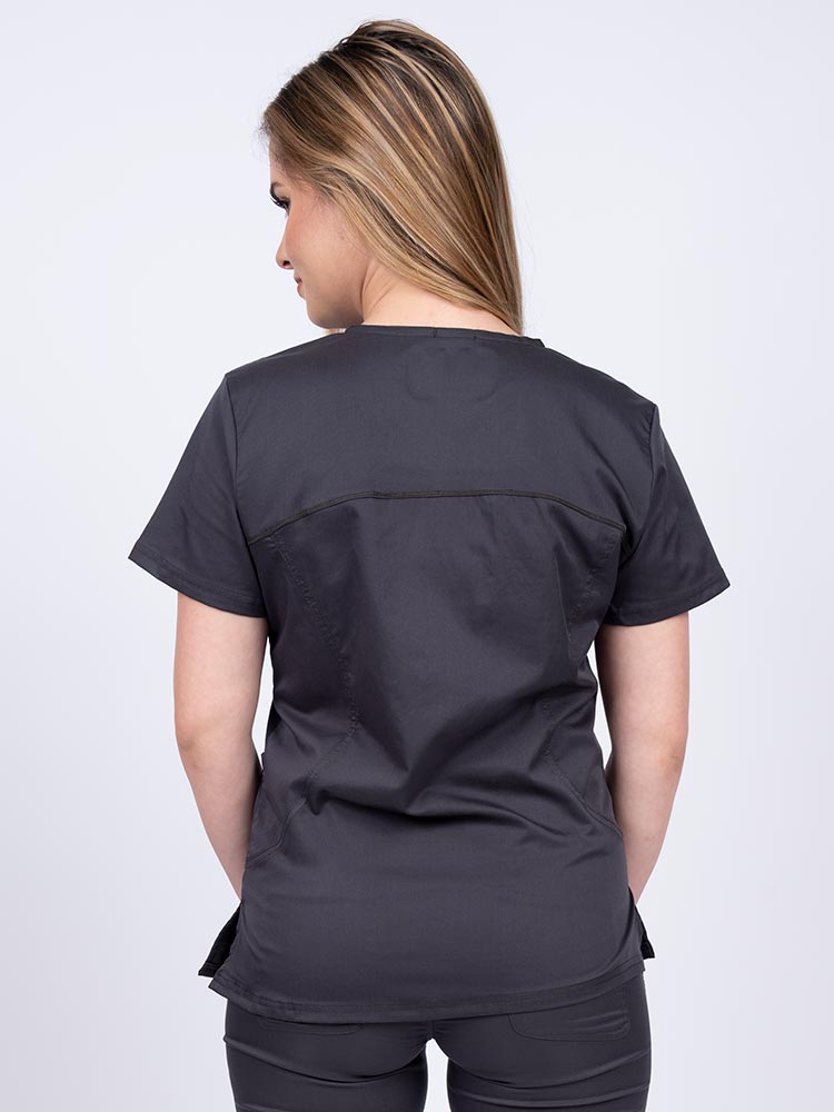 Young female nurse wearing an Epic by MedWorks Women's Knit Collar Mock Wrap Scrub Top in pewter with stylish seaming throughout.