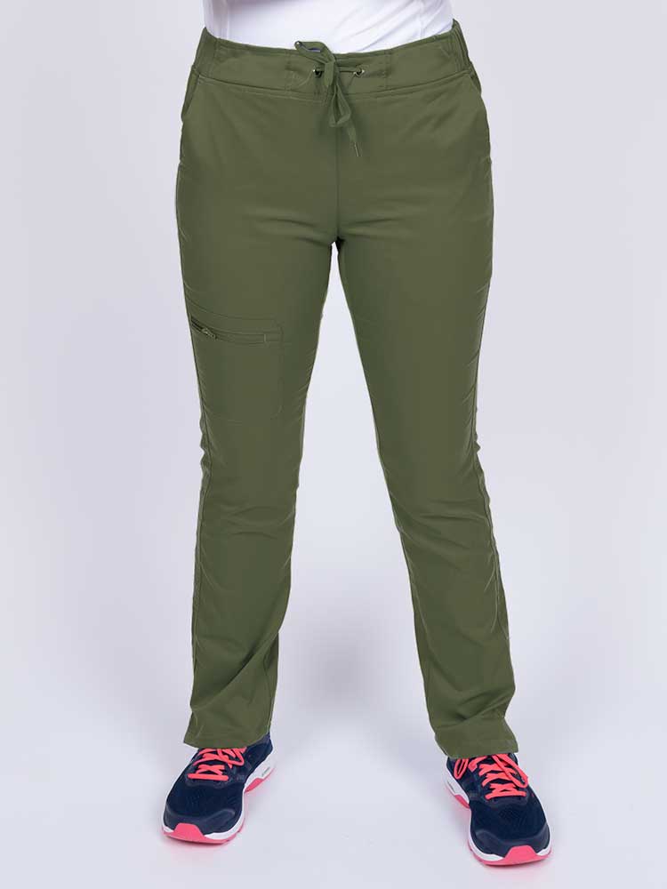 Young healthcare worker wearing an Epic by MedWorks Women's Blessed Skinny Yoga Scrub Pant in olive featuring side slits for additional range of motion.