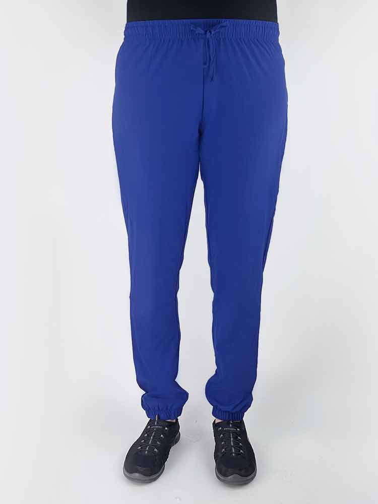 Nurse wearing a Luv Scrubs by MedWorks Women's Pocketless Jogger in royal with an elastic, drawstring waist.