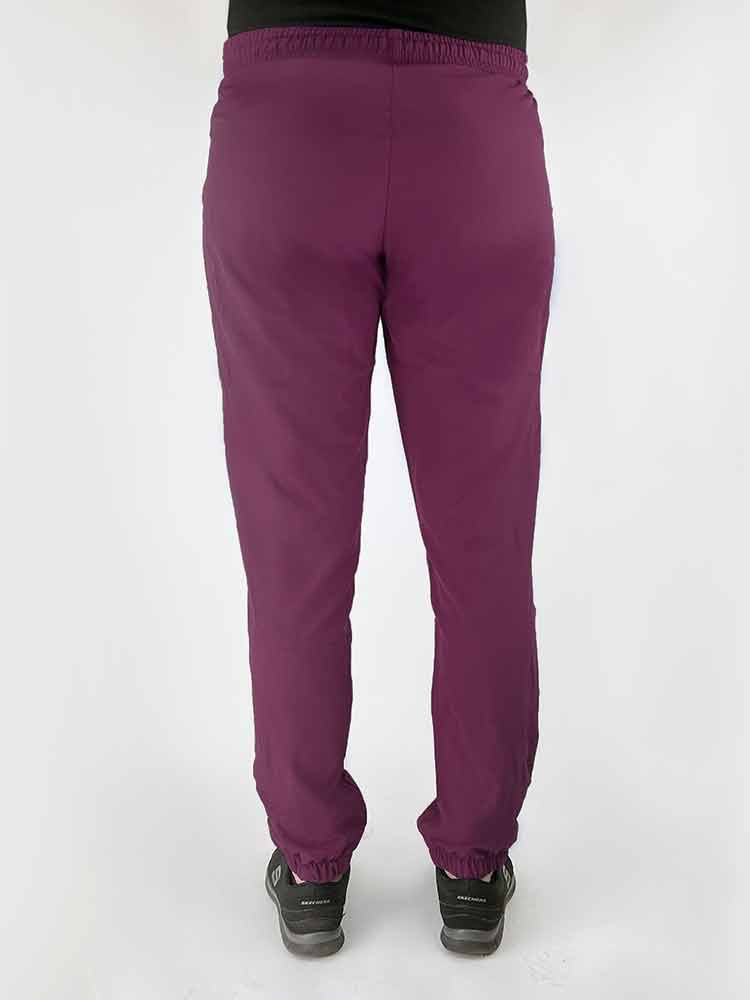 Young woman wearing a Luv Scrubs by MedWorks Women's Pocketless Jogger in wine featuring a missy fit.