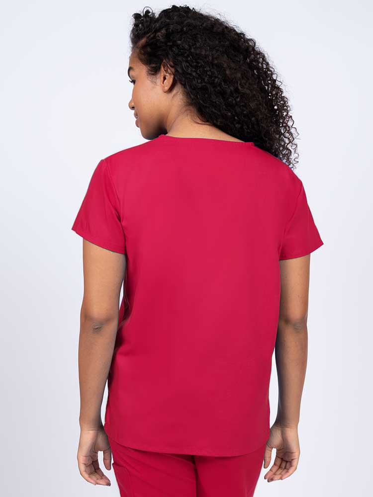 Woman wearing a Luv Scrubs by MedWorks Women's V-neck Scrub Top in red with a center back length of 26".