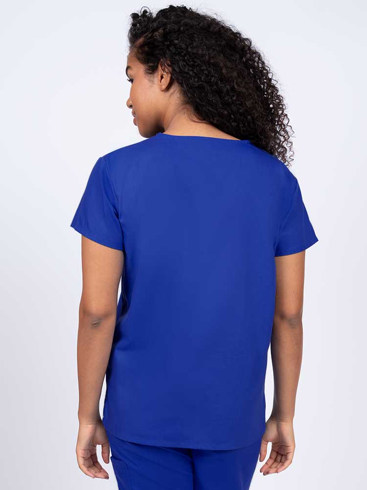 Woman wearing a Luv Scrubs by MedWorks Women's V-neck Scrub Top in royal with a center back length of 26".
